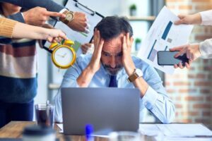 Group of business workers working together. Partners stressing one of them at the office